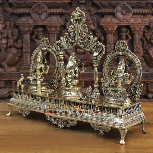 brass ganesh, lakshmi, and saraswati idols